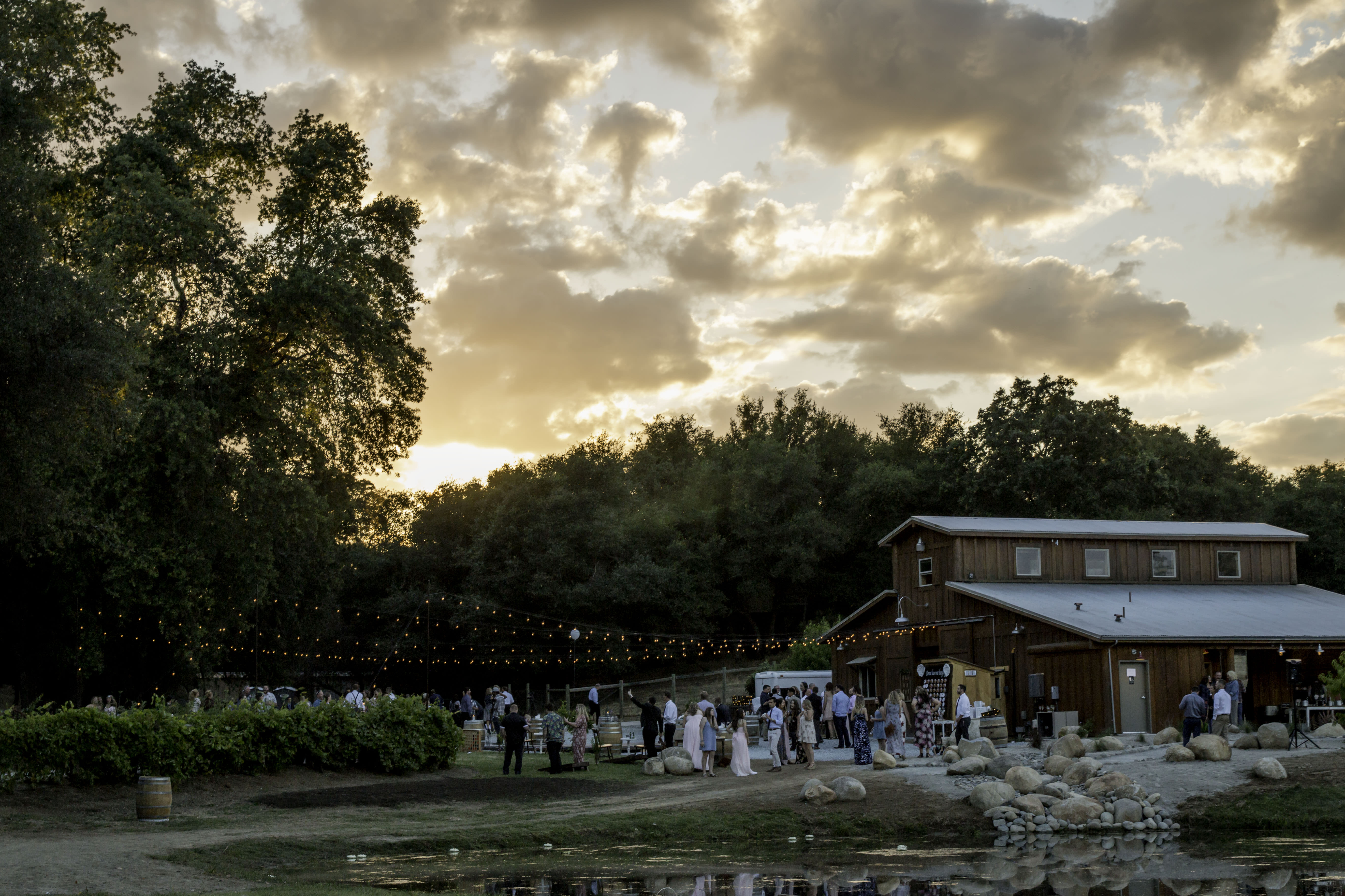 An outdoor wedding reception at a barn.