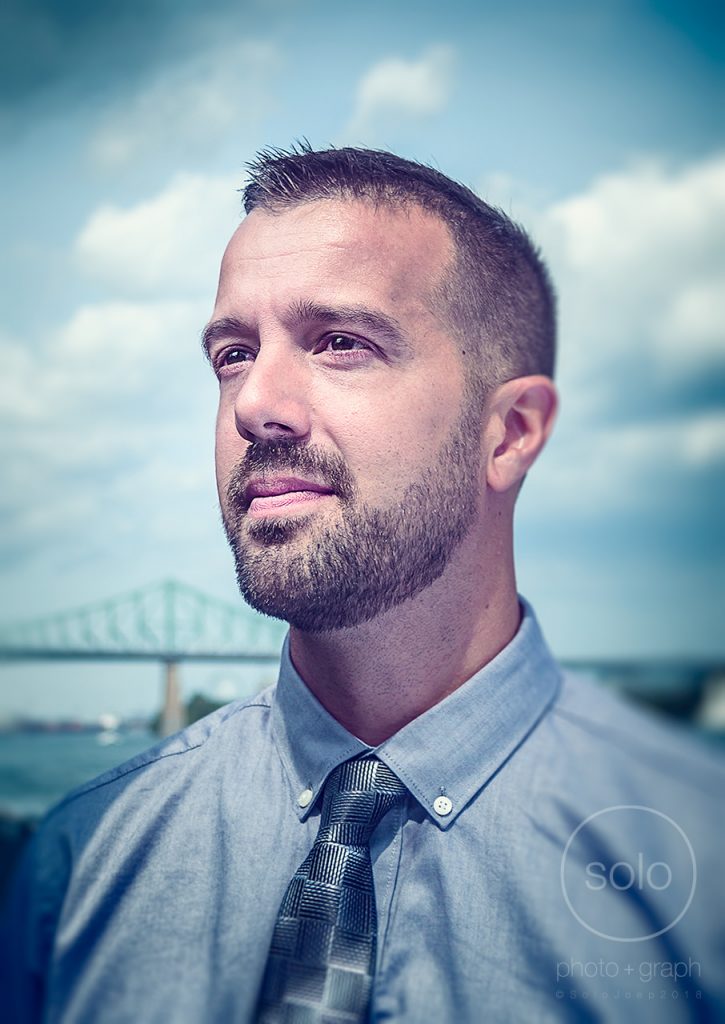 Image of a man in business attire photographed outdoors using unique portrait lighting