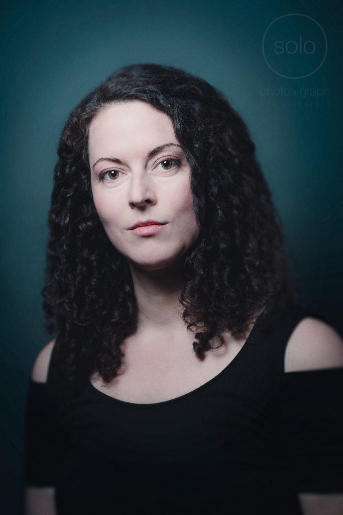 Example of a creative portrait of an actress with dark curly hair