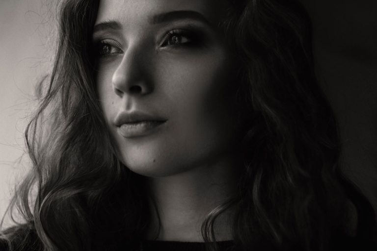 Black and white headshot of a brunette woman looking off camera.