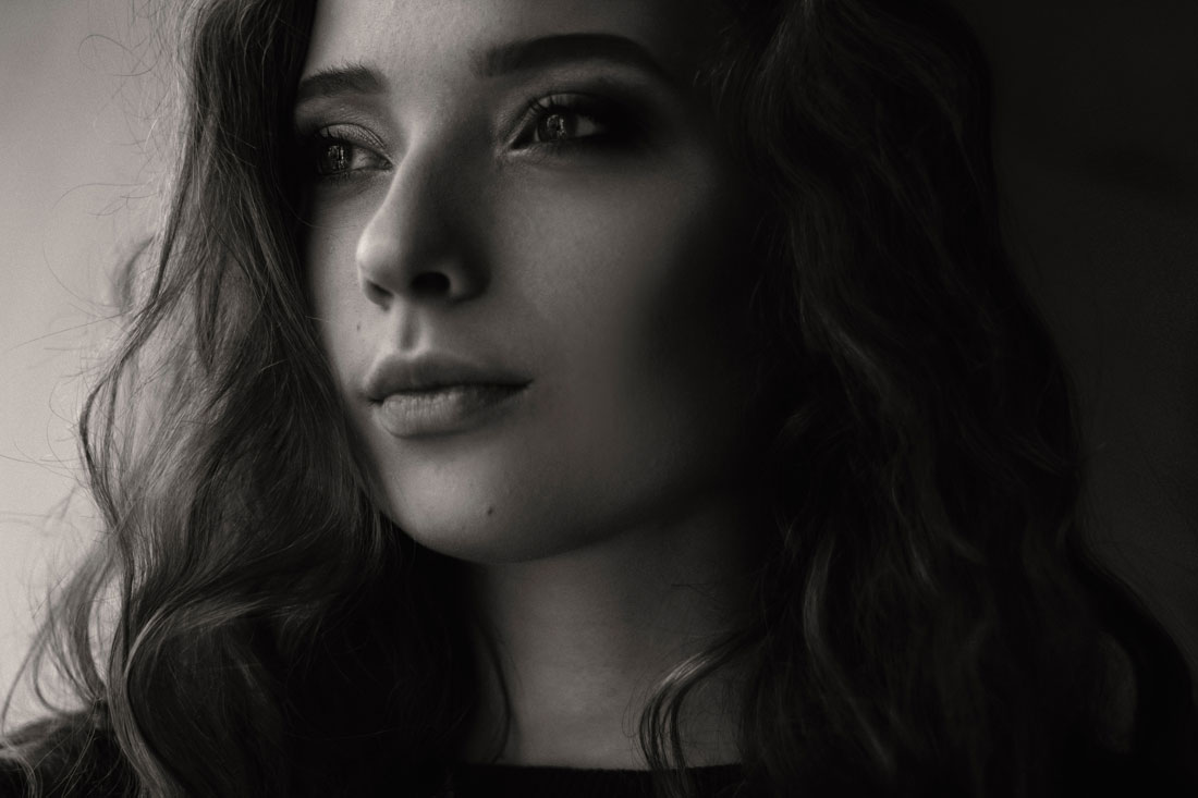 Black and white headshot of a brunette woman looking off camera.
