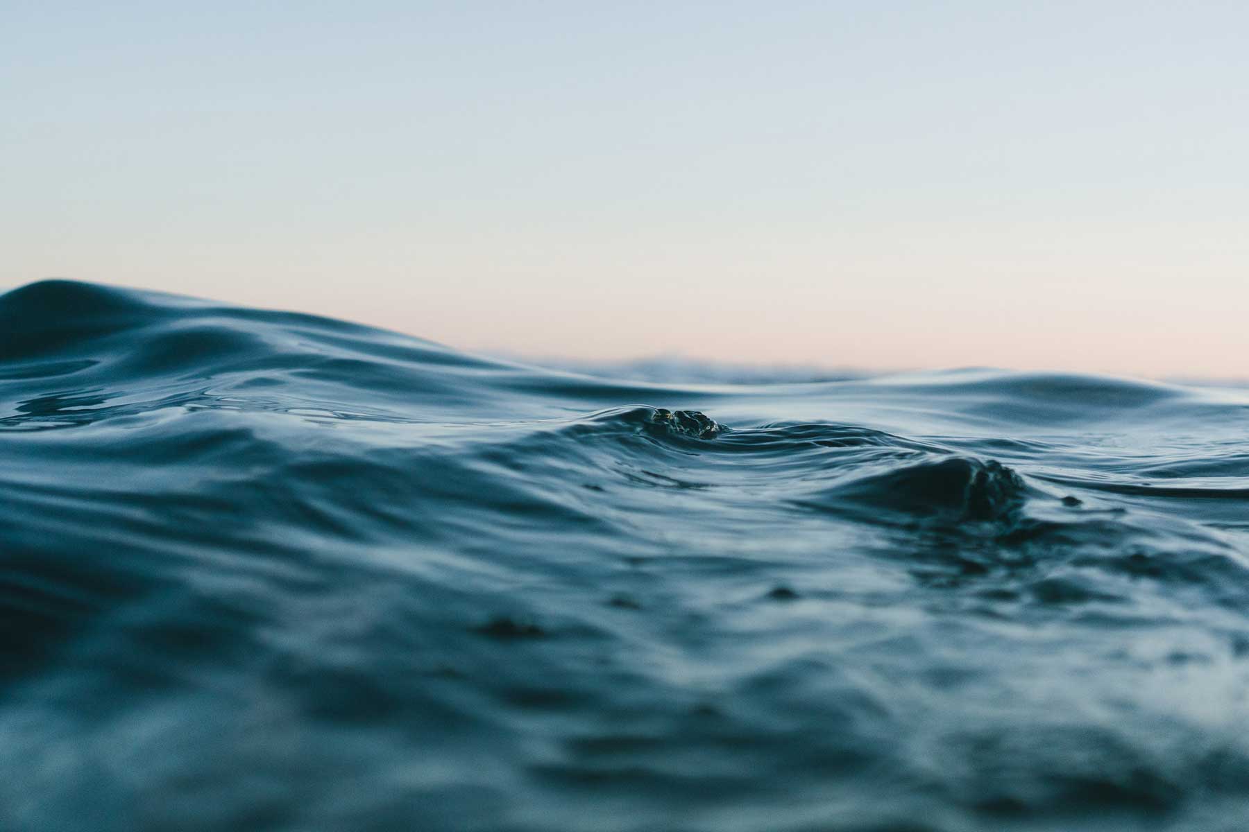 Waves of water and a clear sky.