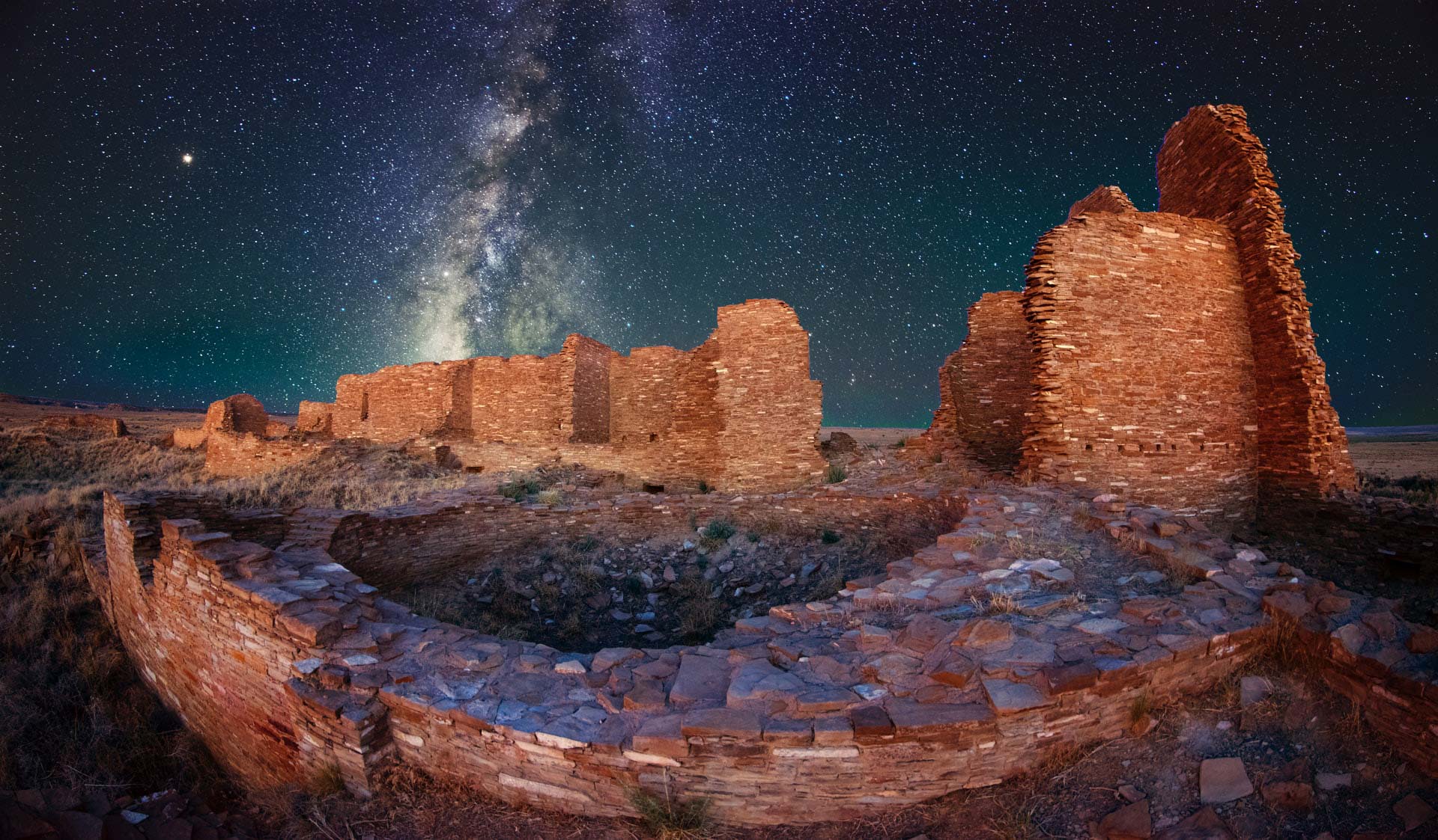Stone ruins with the night sky and milky way in the background.