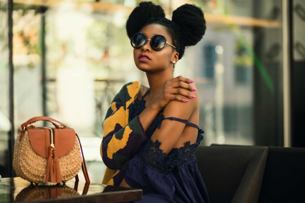 Fashion photo shoot of a woman wearing a navy blue dress and a purse