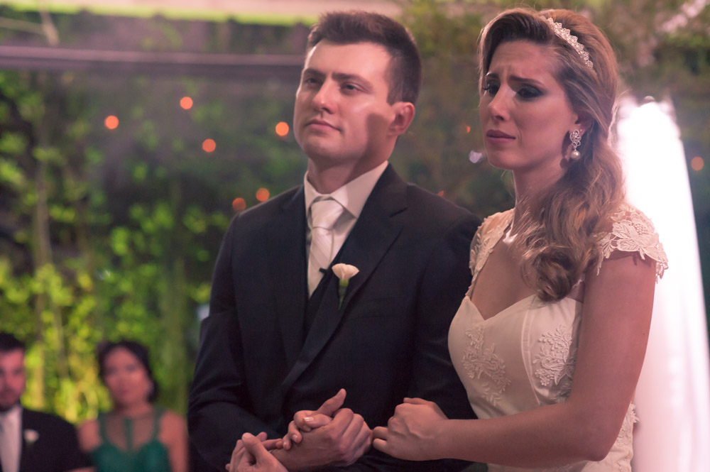 Wedding photography image of a bride and groom at the alter listening to their priest