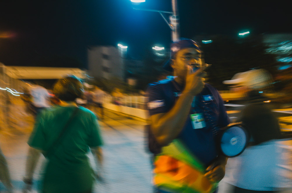 A man on a loudspeaker out of focus.