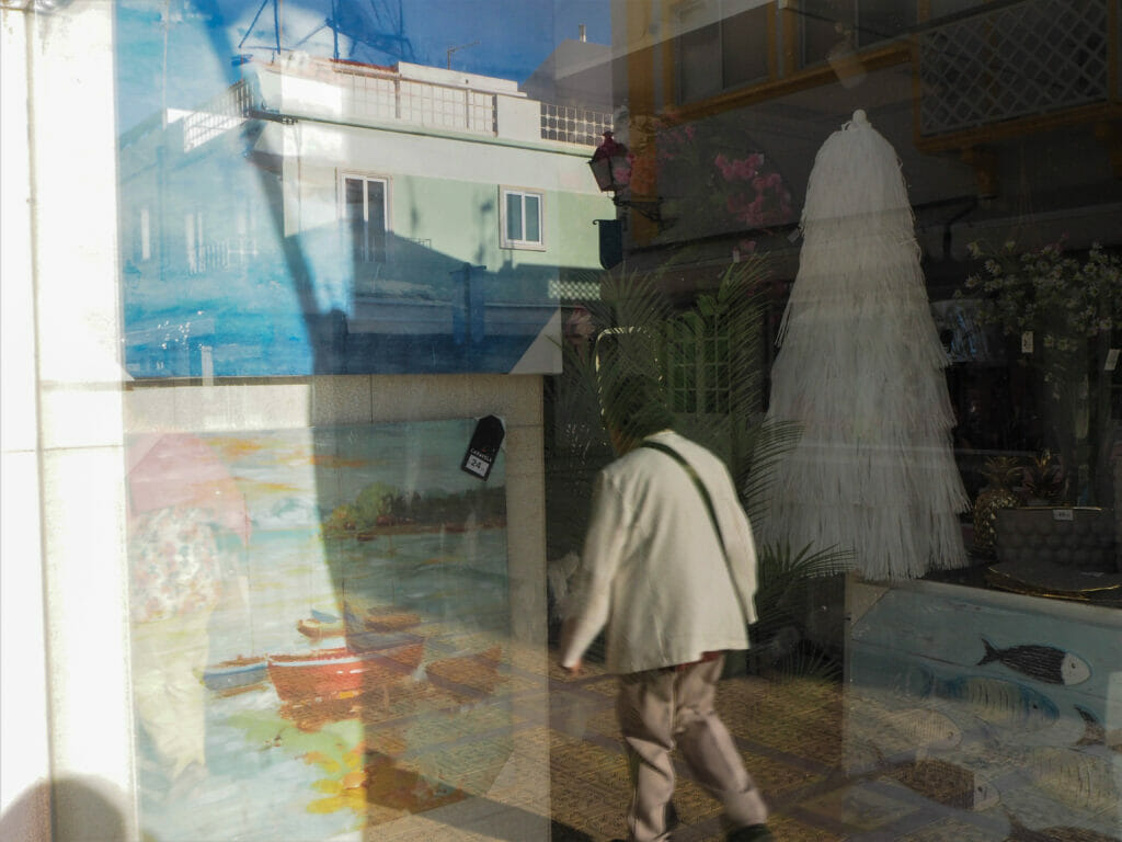 A person in the reflection of a window.